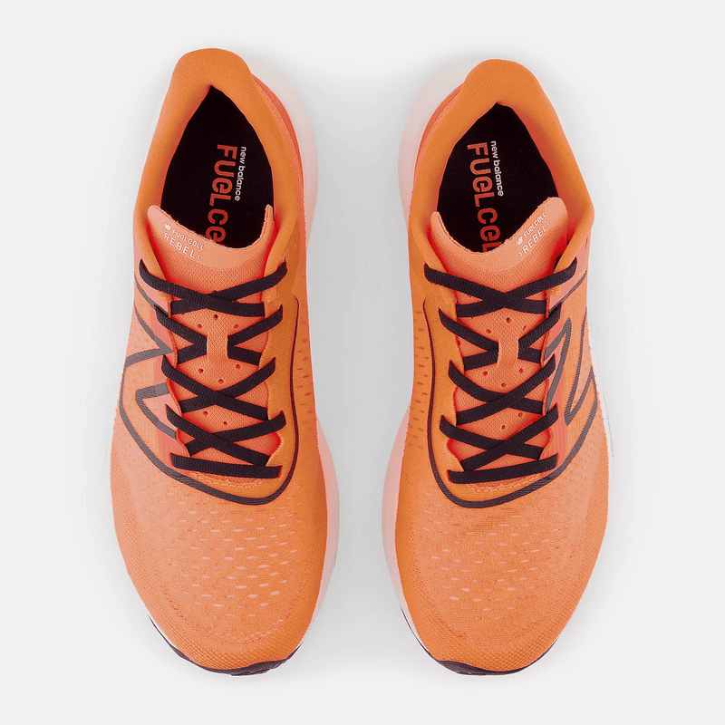 New Balance FuelCell Rebel v3 running shoes in vibrant orange with black details, lightweight mesh upper, top view.