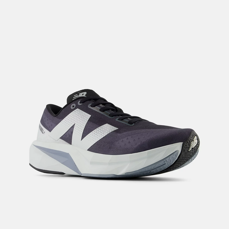 New Balance FuelCell Rebel v4 running shoes in black and white with a breathable mesh upper and FuelCell midsole, angled front view.