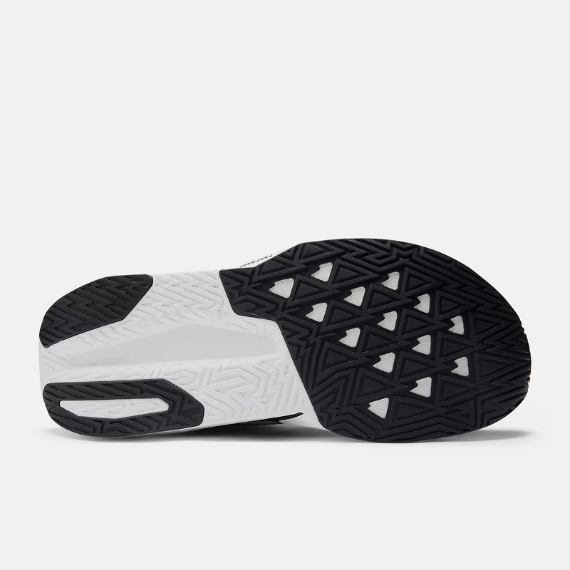 New Balance FuelCell Rebel v5 running shoes outsole featuring black and white rubber with geometric tread patterns, bottom view.
