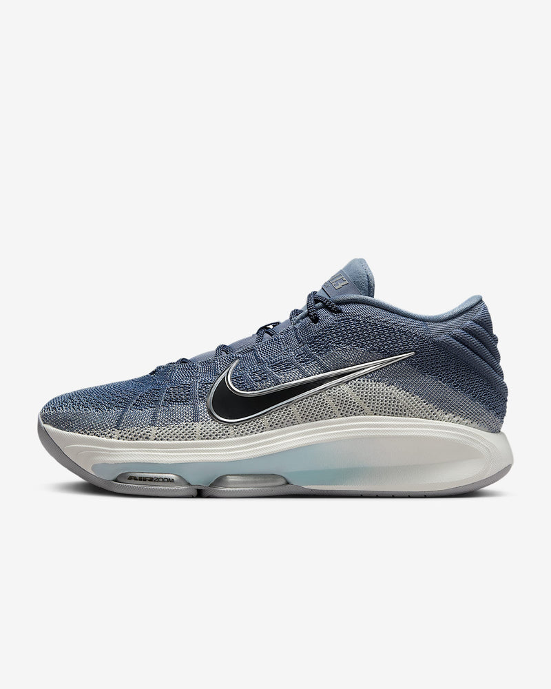 Nike G.T. Hustle 3 basketball shoes in blue and gray mesh with Air Zoom cushioning and black Nike swoosh, side view.
