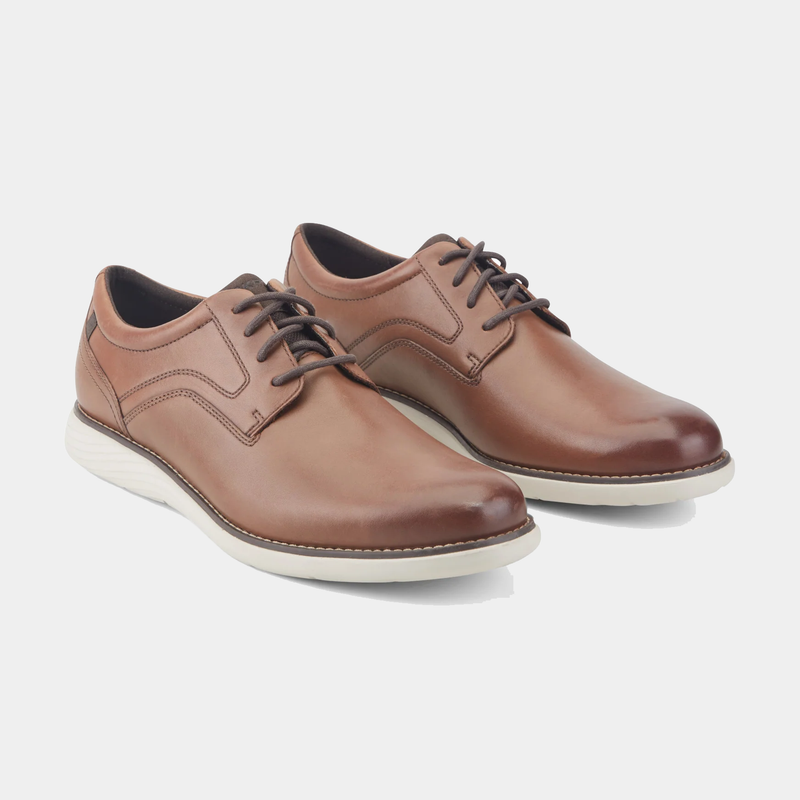 Rockport Garett Plain Toe leather dress shoes in brown with lace-up closure and white rubber outsole, angled front side view.