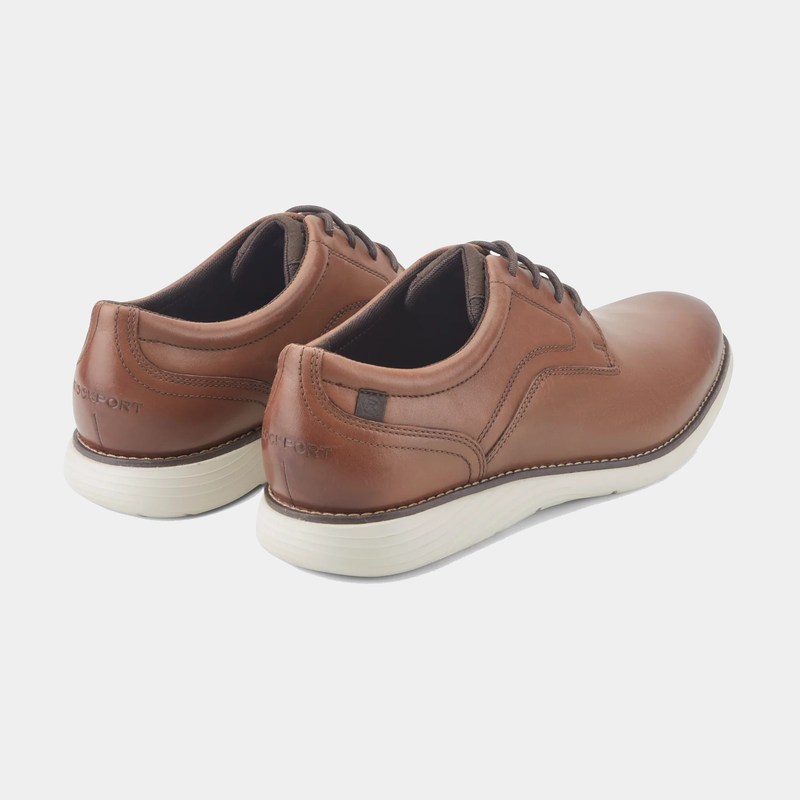 Rockport Garett Plain Toe shoes in tan leather with contrast stitching and white EVA outsoles, back angle view.