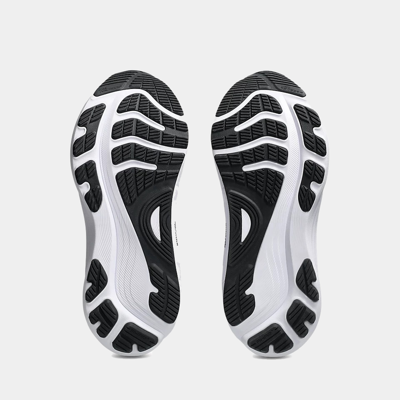 Asics Gel-Kayano 32 running shoes outsole showing black rubber tread with white accents and flex grooves.