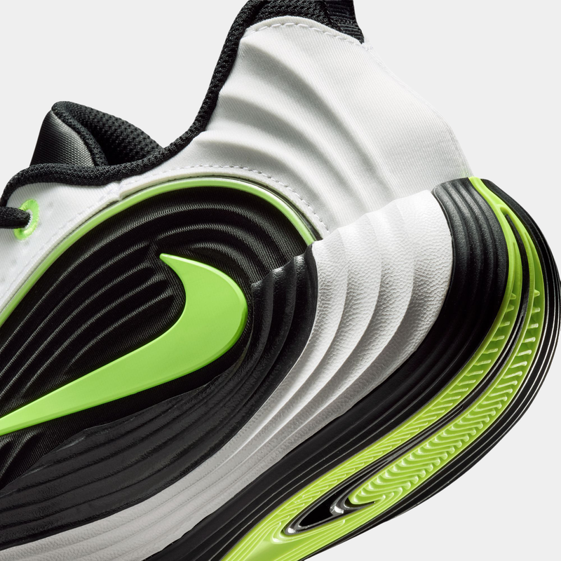 Nike Giannis Immortality 5 basketball shoes, black and white midsole with green accents and textured ripple design, side view.