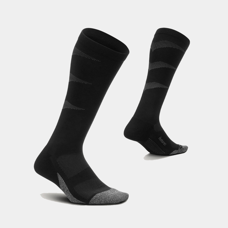 Feetures Graduated Compression Light Cushion Socks, black with gray toe and heel accents, featuring breathable mesh panels and knee-high design, angled view.