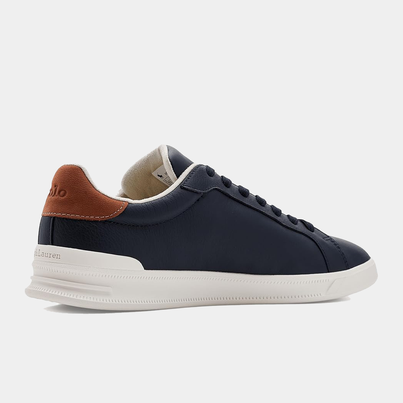 Polo Ralph Lauren Heritage Court II Leather sneakers in navy blue with brown heel accent and white sole, side view.
