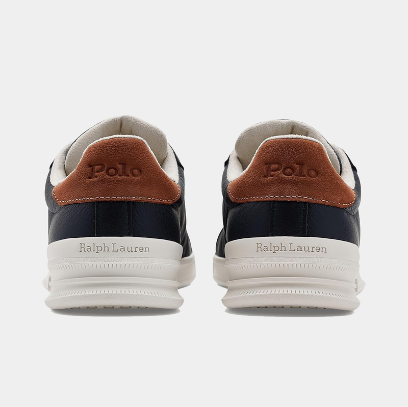 Polo Ralph Lauren Heritage Court II Leather sneakers in navy leather with brown suede heel tabs and white midsoles, back view.