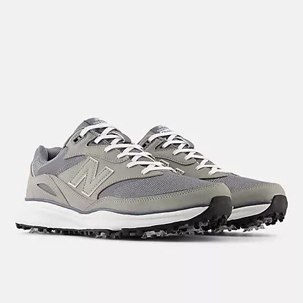 New Balance Golf Heritage Golf shoes in gray with mesh upper, synthetic overlays, spikeless outsole, and white laces, front angled view.