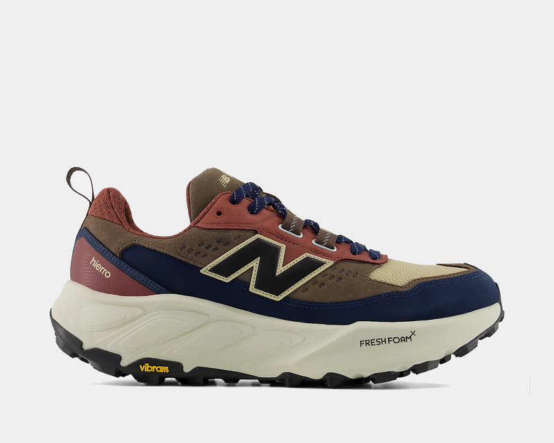 New Balance Hierro Trek hiking shoes in navy, tan, and burgundy with Vibram outsole and Fresh Foam midsole, side view.