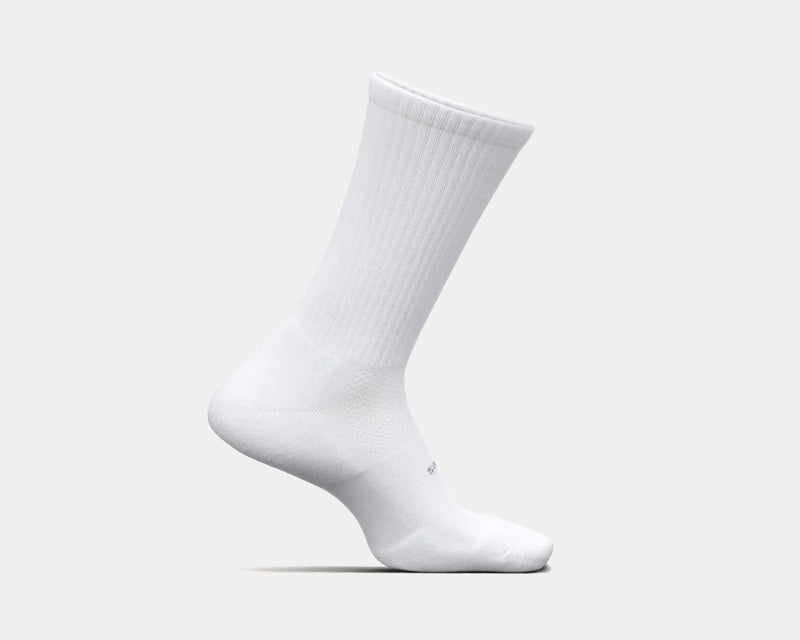 Feetures High Performance Max Cushion Crew socks in white with ribbed upper and cushioned sole, side view.