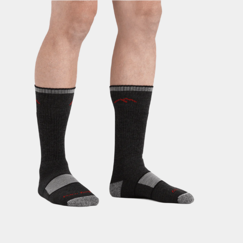 Darn Tough Hiker Boot Midweight Hiking Sock in black and gray with red accents, worn by person standing.