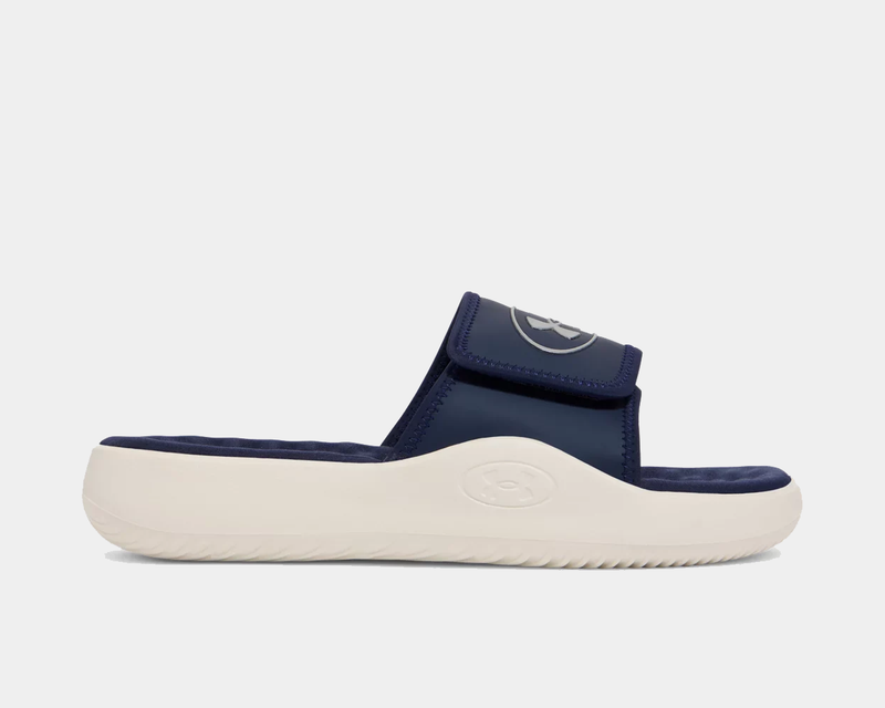 Under Armour Ignite Pro 8 Slides in navy blue with adjustable strap and white cushioned sole, side view.