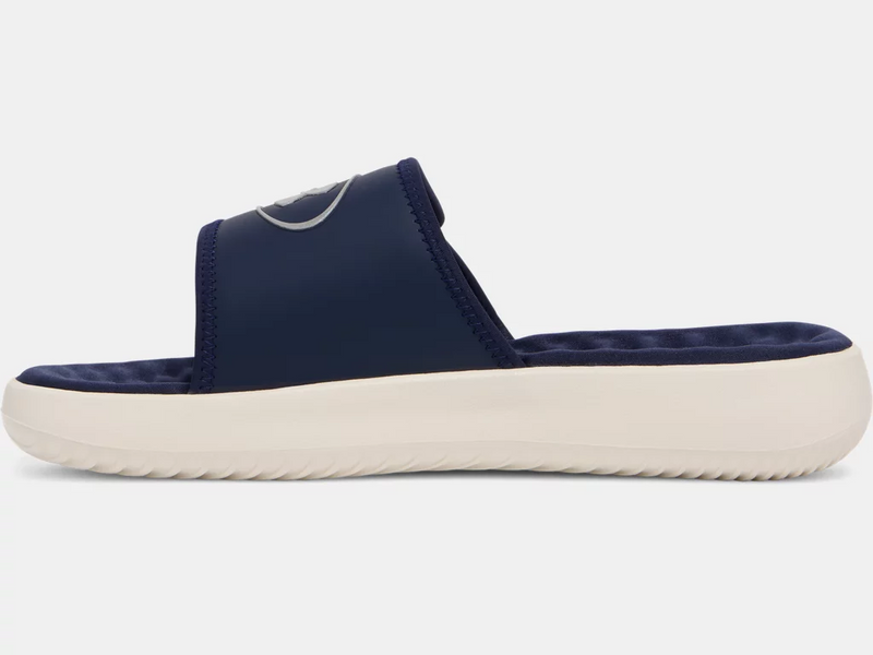 Under Armour Ignite Pro 8 Slides in navy blue with cushioned footbed and cream outsole, side view.