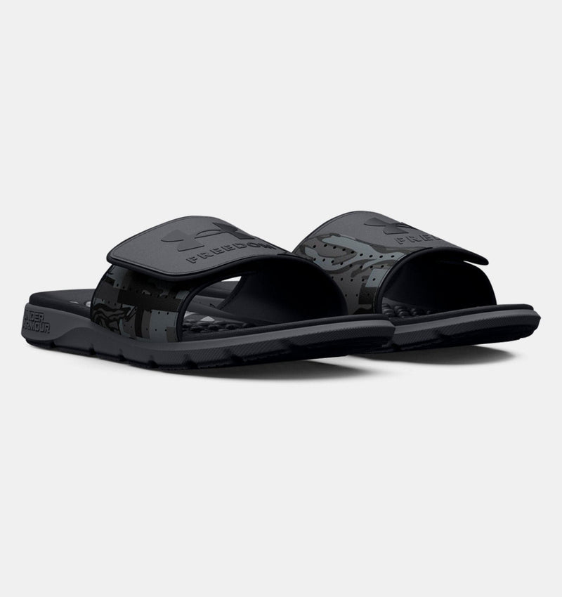 Under Armour Ignite Pro Freedom Slides, black with textured footbed and camo-print adjustable straps, angled front view.
