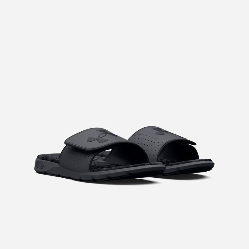 Under Armour Ignite Pro Graphic Strap Slides in black with perforated adjustable straps and cushioned footbed, angled front view.