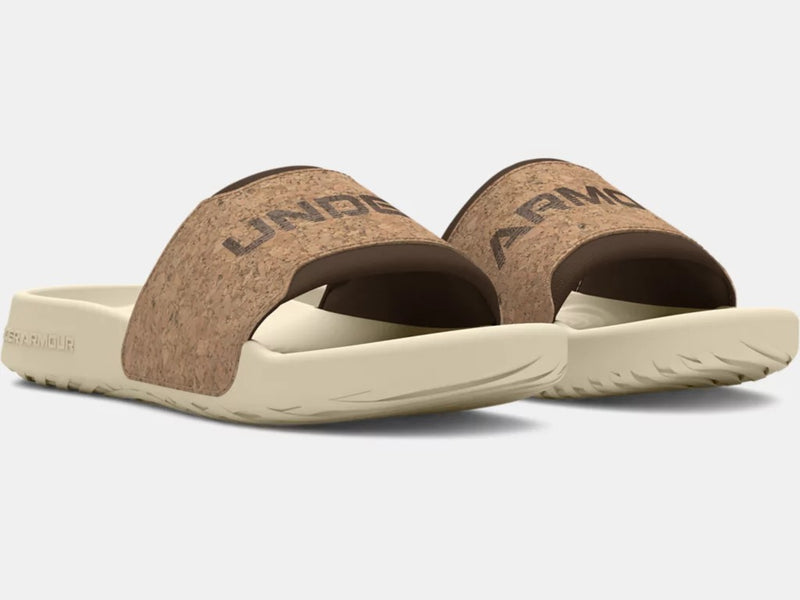 Under Armour Ignite Select Cork Slides featuring a cork-textured strap with logo detailing and beige cushioned sole, front angle view.