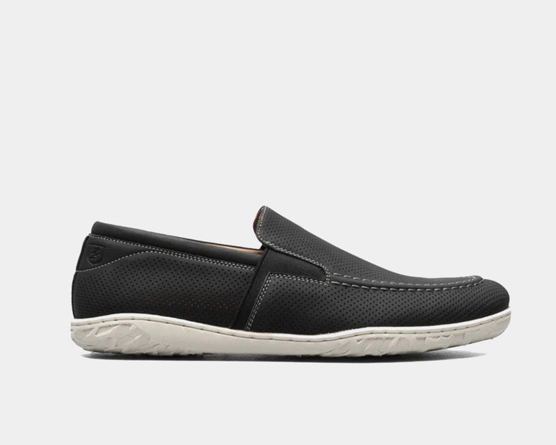 Stacy Adams Ilan slip-on shoes in black perforated leather with white textured sole, side view.