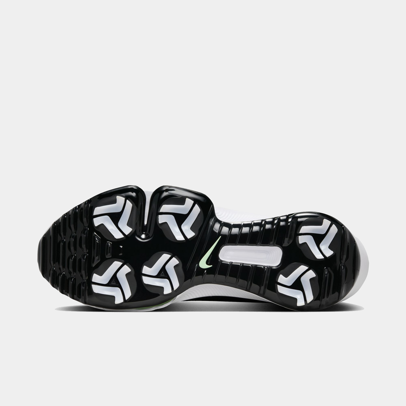 Nike Infinity Tour 2 golf shoes outsole with black and white traction pattern and green Nike swoosh detailing.