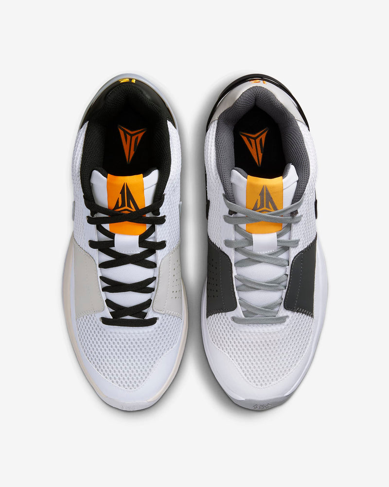 Nike Ja 1 "Wet Cement" basketball shoes top view showing white mesh upper, gray and black accents, and orange tongue details.