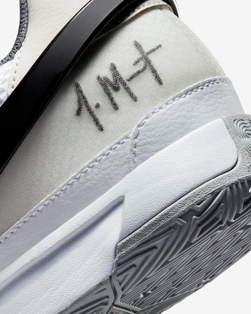 Nike Ja 1 "Wet Cement" basketball shoe in white with textured midsole, black heel detail, and signature graphic, close-up heel view.