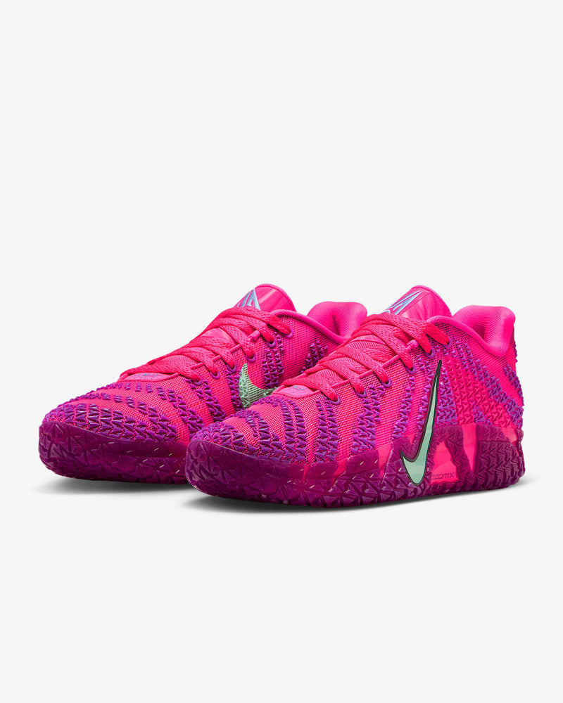 Nike Ja 3 "Price of Admission" basketball shoes in vibrant pink with purple accents, mesh upper, green Swoosh logo, and textured outsole, front angle view.