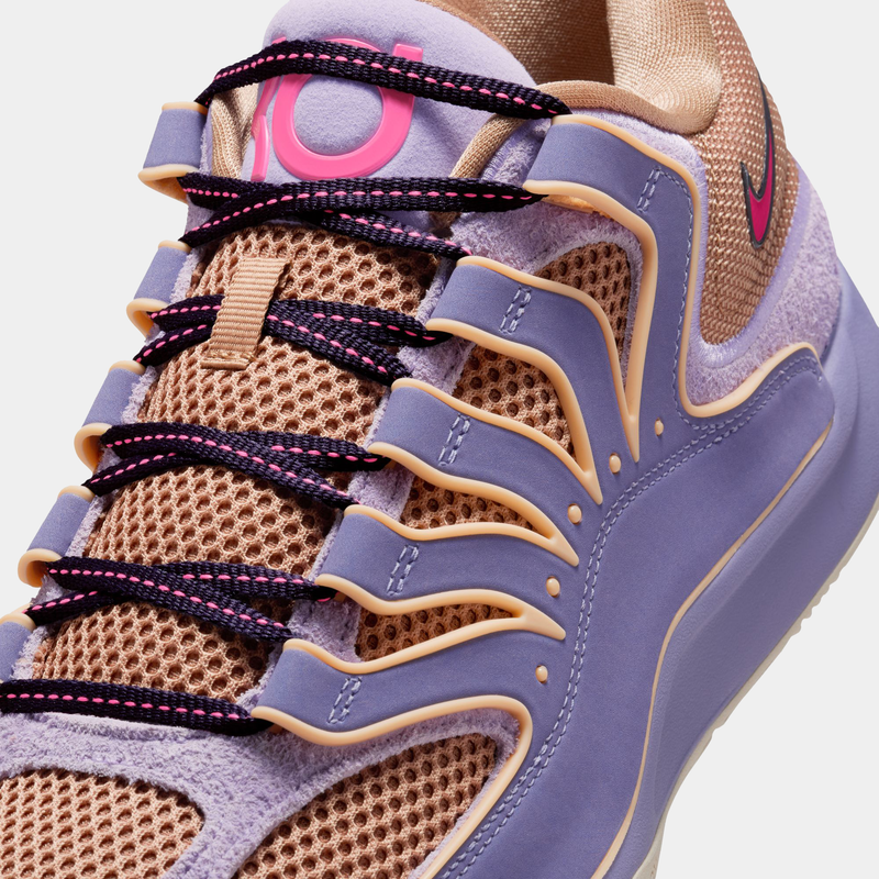 Nike KD 18 basketball shoes featuring beige mesh upper, purple overlays, black laces with pink accents, and KD logo detail, close-up view.