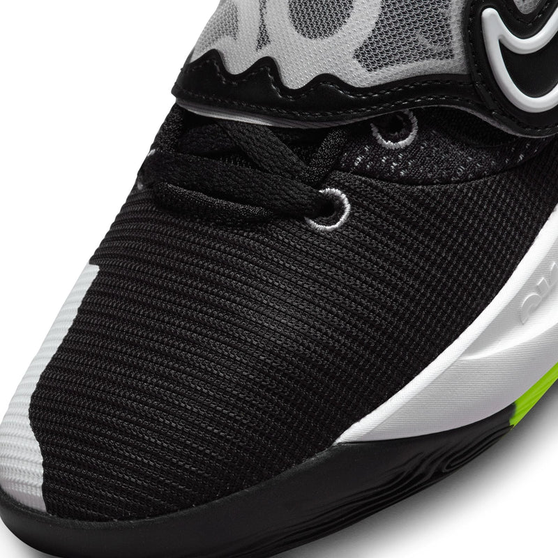 Nike KD Trey 5 X basketball shoes close-up showing black mesh upper, white accents, reinforced eyelets, and cushioned midsole.