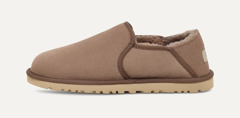 UGG Kenton slippers in chestnut brown suede with plush shearling lining and durable treaded sole, side view.