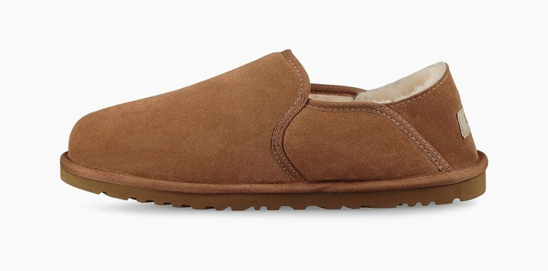 UGG Kenton slipper in chestnut brown suede with plush shearling lining and durable rubber outsole, side view.