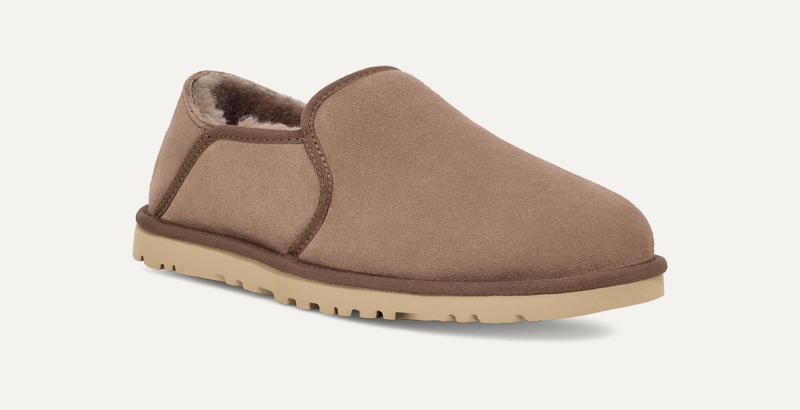 UGG Kenton slip-on shoes in tan suede with plush shearling lining and a lightweight beige rubber outsole, side-front angle view.