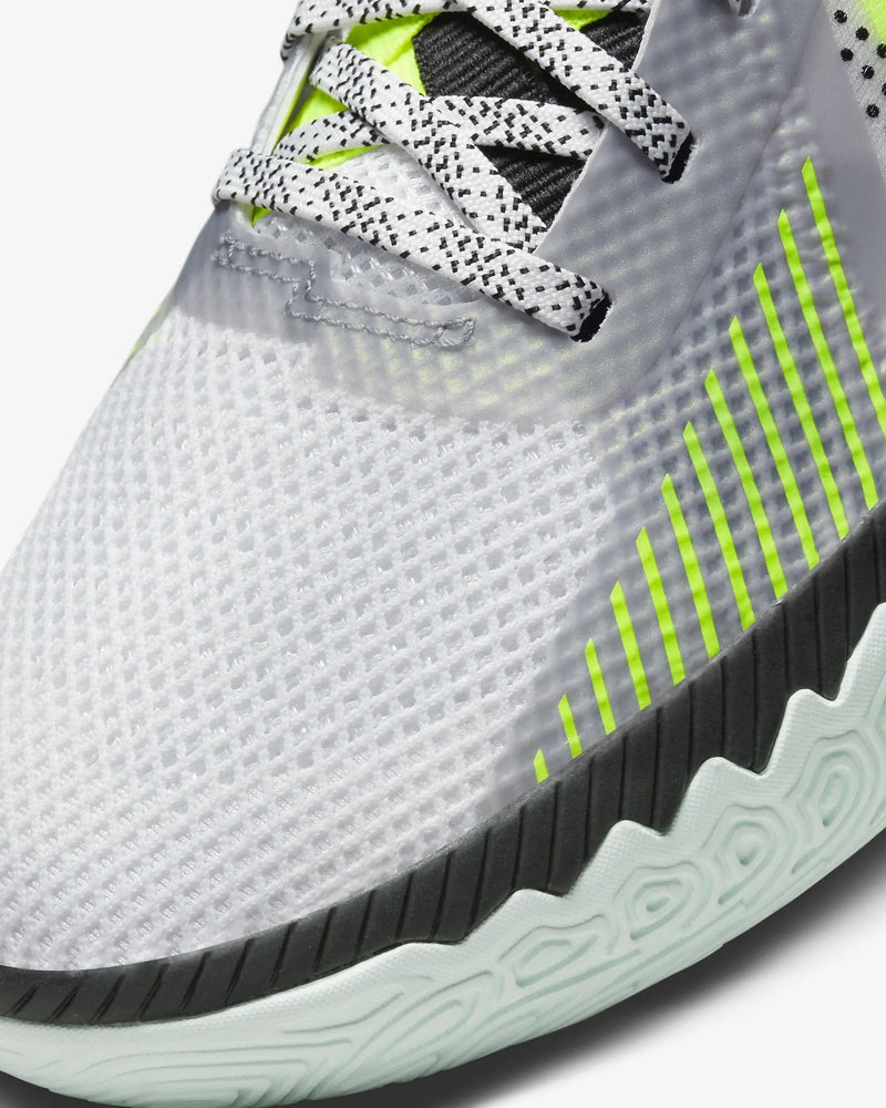 Nike Kyrie Flytrap V basketball shoes, close-up of the white mesh upper with neon green accents and black outsole detailing.