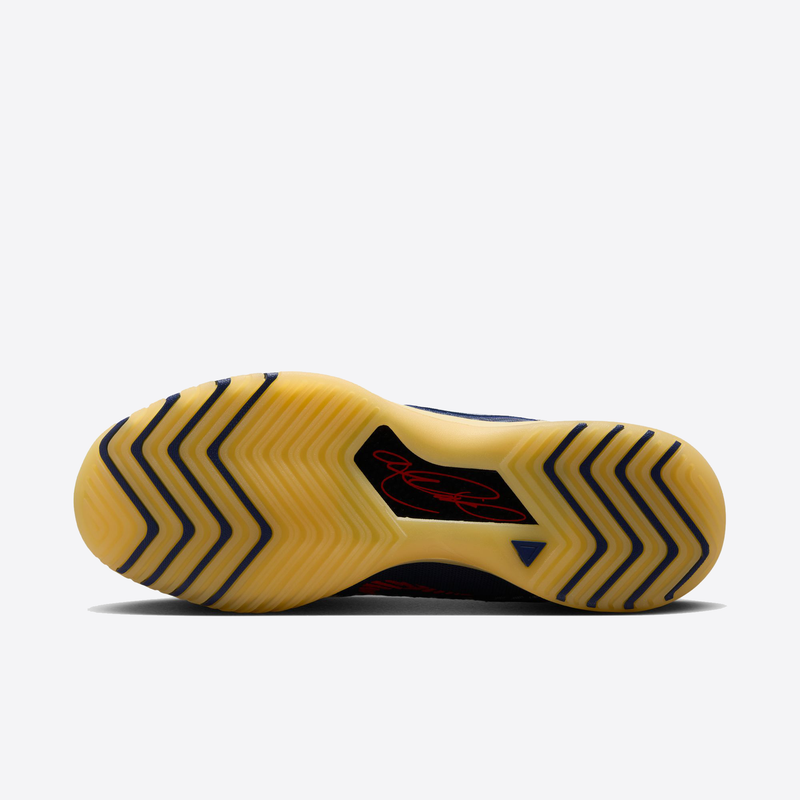 Nike LeBron NXXT Genisus basketball shoes outsole showing herringbone tread pattern and signature detail in yellow and red.
