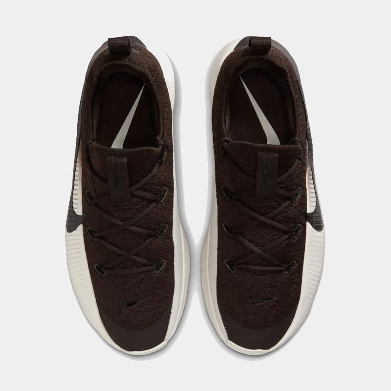 Pair of brown sneakers with white soles on a light gray background