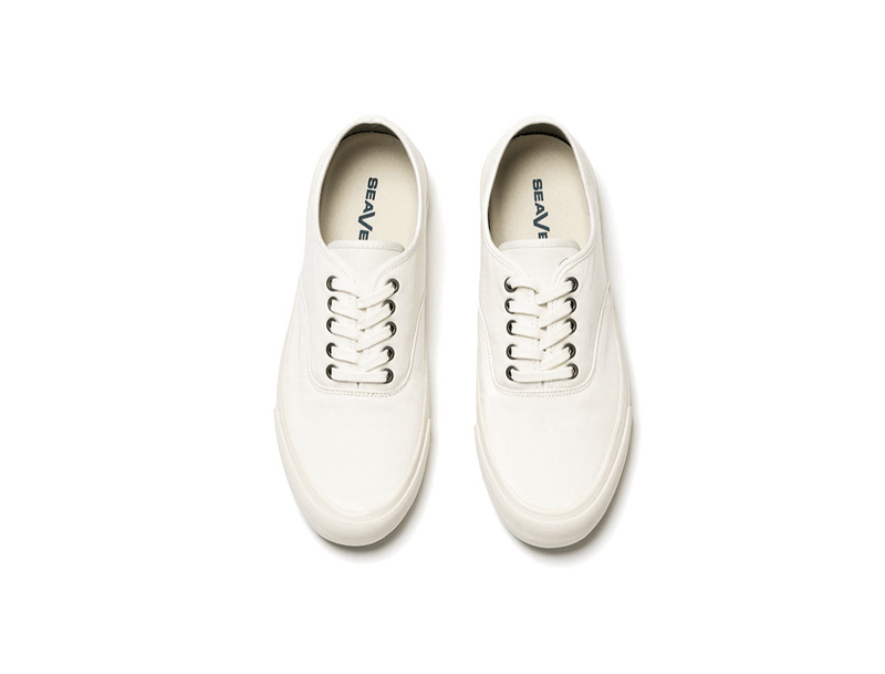 SeaVees Legend Sneaker Standard sneakers in off-white canvas with metal eyelets and flat laces, top view.