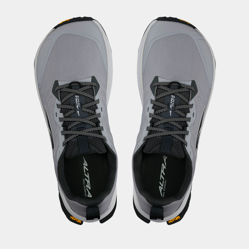 Altra Lone Peak 9+ trail running shoes in light gray with a mesh upper, dark gray laces, and Vibram outsole, top view.