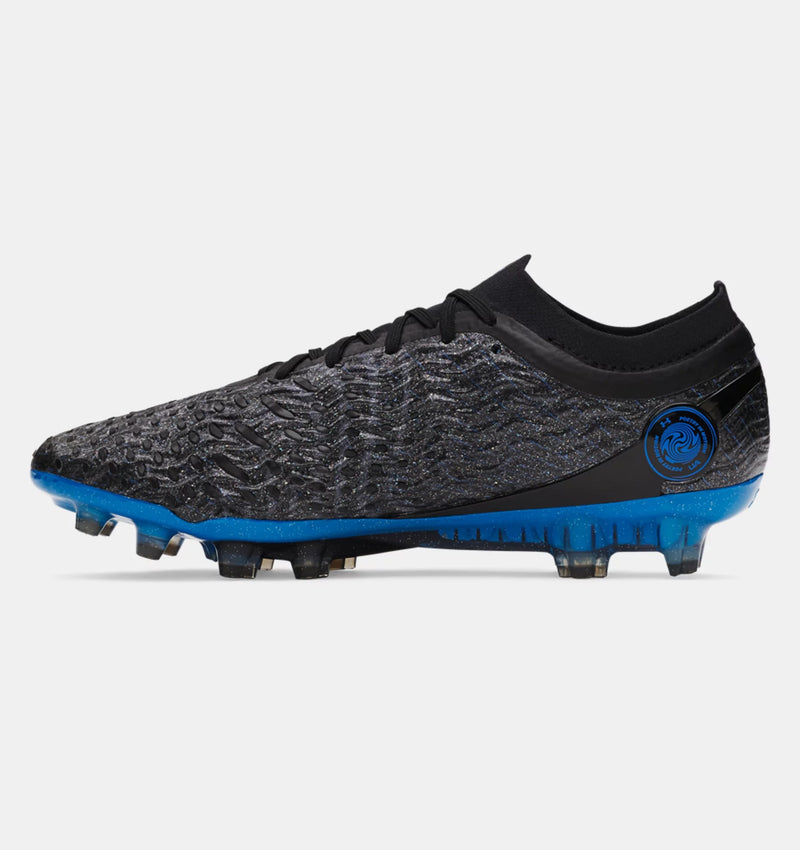 Under Armour Magnetico Elite 5 FG soccer cleats in black with textured synthetic upper and blue soleplate, side view