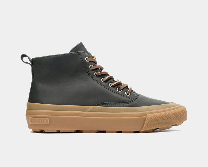 SeaVees Mammoth Boot in black leather with gum rubber outsole, brown laces, and pull tab, side view.