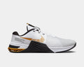 Nike Metcon 8 training shoes side view in white with gold accents, breathable mesh upper, and black textured midsole.