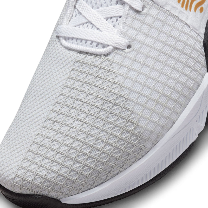 Nike Metcon 8 training shoe close-up of white mesh upper with textured grid pattern and durable design.