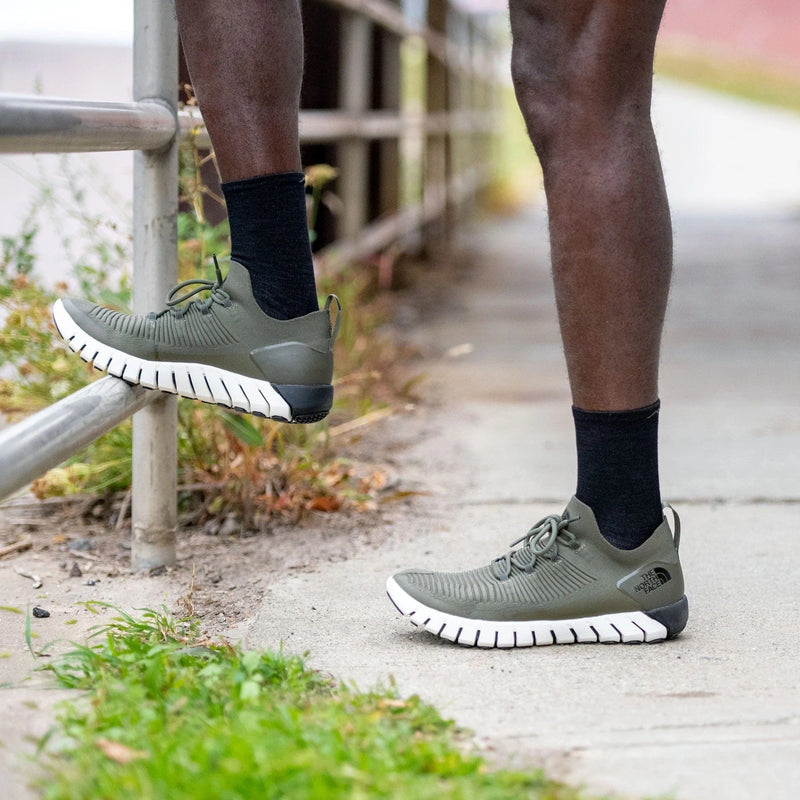Darn Tough Micro Crew Ultra-Lightweight Running Sock in black, ultra-light design with crew height, worn during outdoor activity.