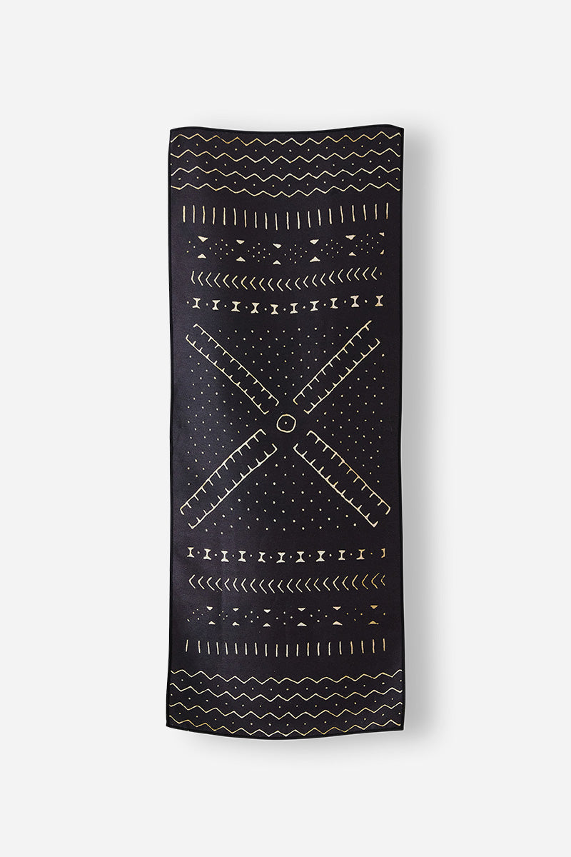 Nomadix Mini Towel black with gold geometric patterns and soft, quick-drying material, flat front view.