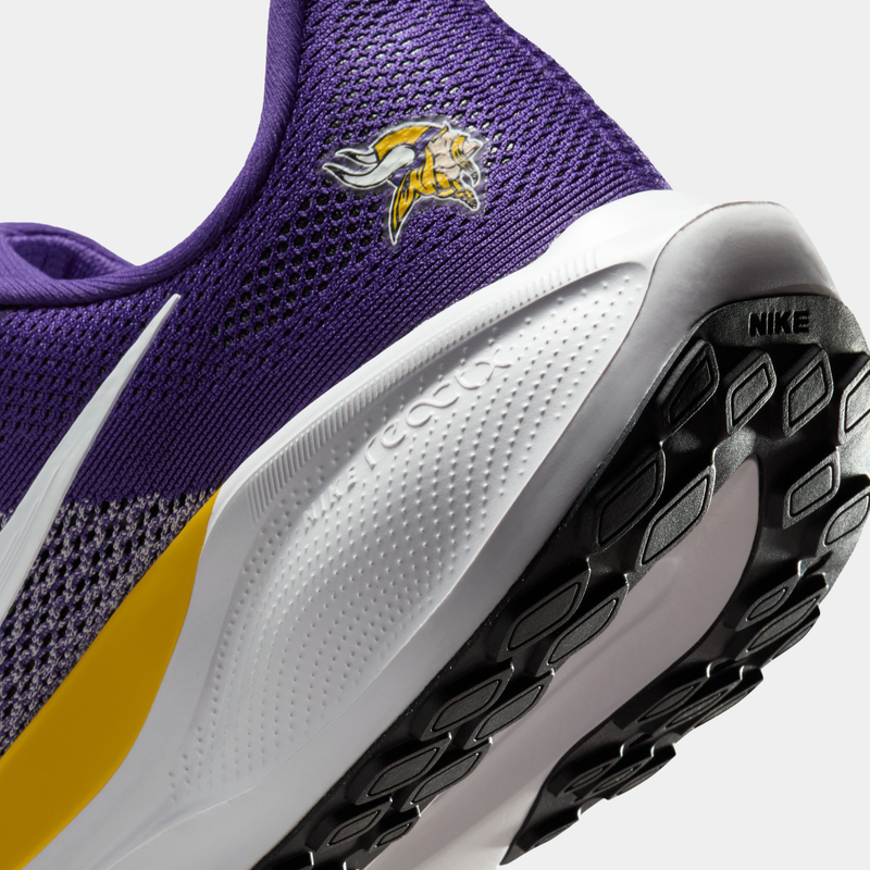 Nike Minnesota Vikings Pegasus 41 running shoes, purple mesh upper with yellow details, Vikings logo, white React foam sole, close-up heel view.