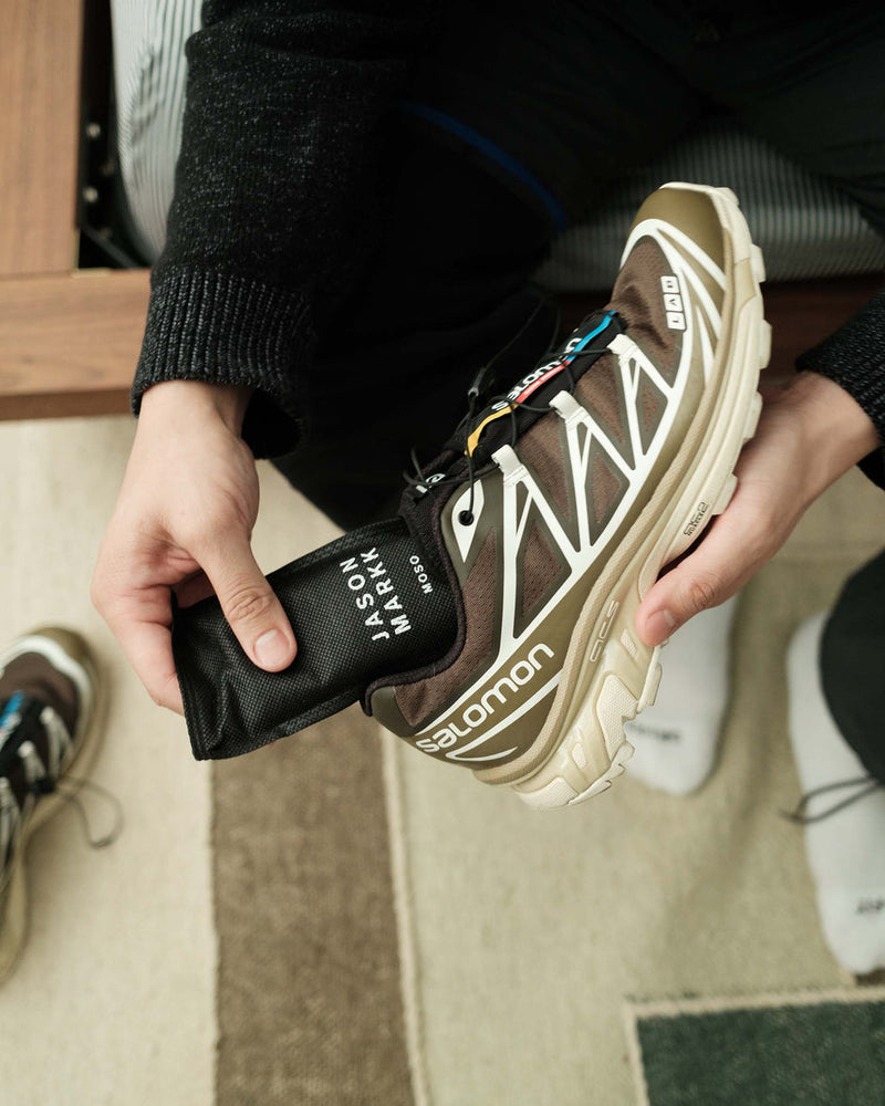Jason Markk Moso Freshener Shoe Inserts in black with printed branding, shown being placed into a shoe for odor elimination.