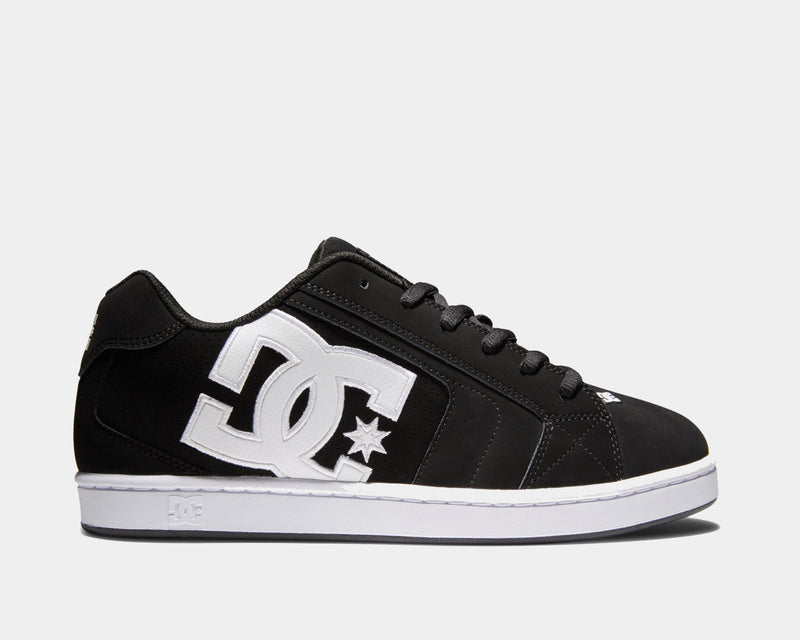 DC Footwear Net shoes in black with white oversized logo embroidery and leather upper, side view.