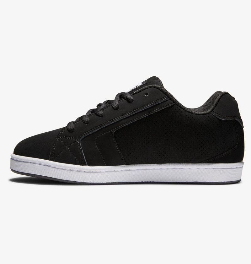 DC Footwear Net sneakers in black with perforated details, padded collar, and white rubber sole, side view.