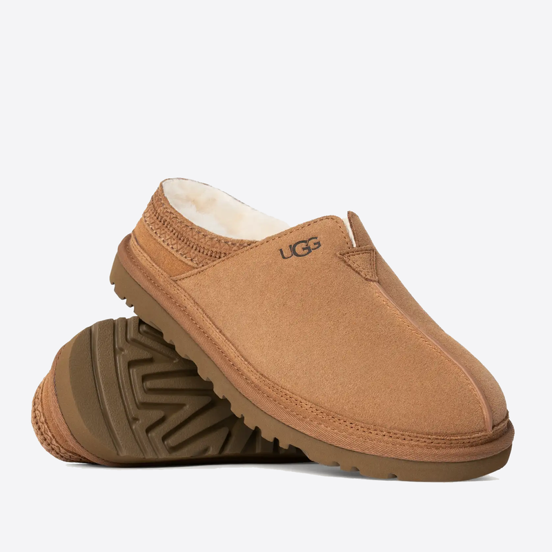 UGG Neuman slippers in chestnut suede with plush sheepskin lining and durable rubber outsole, side and sole view.