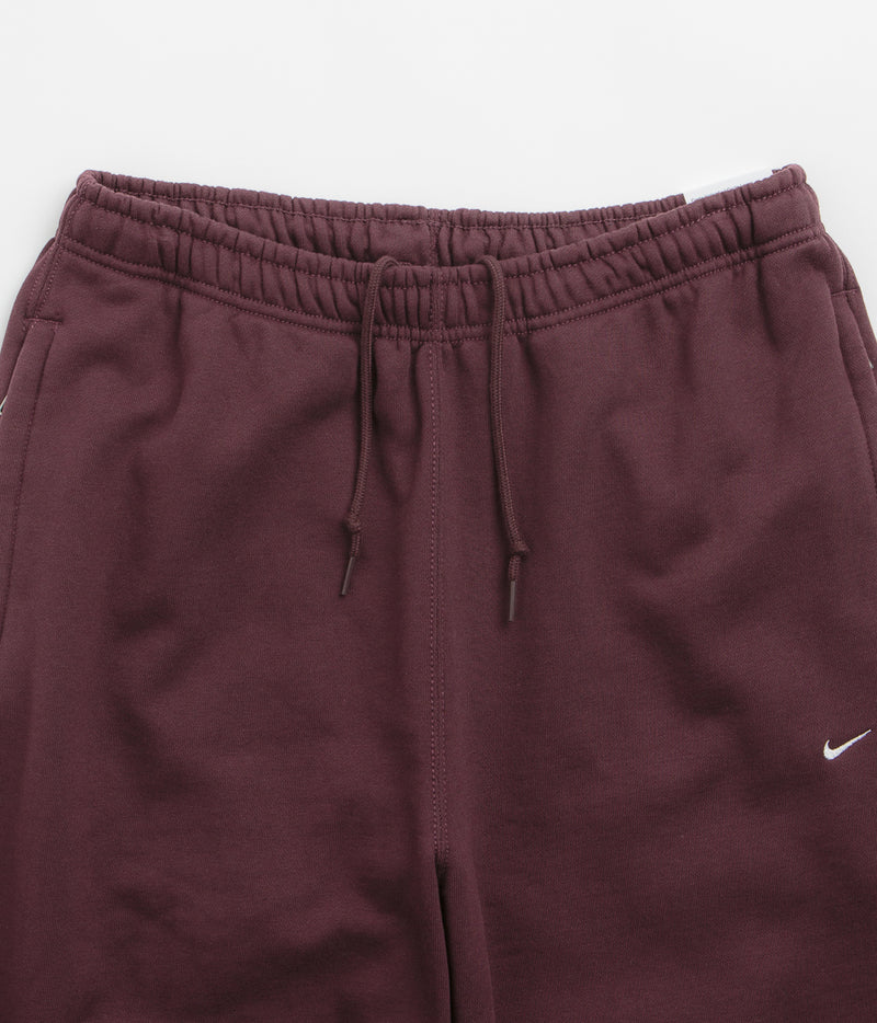 Nike Solo Swoosh Cuffed Sweatpants in Burgundy Crush and Burgundy Crush / White