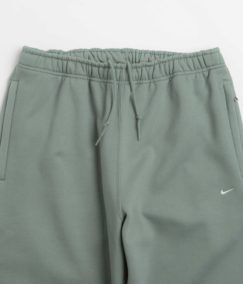 Nike Solo Swoosh Cuffed Sweatpants in Clay Green and Clay Green / White