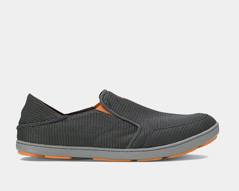 OluKai Nohea Mesh slip-on shoes in charcoal gray with breathable mesh upper, soft gray sole, and orange accents, side view.