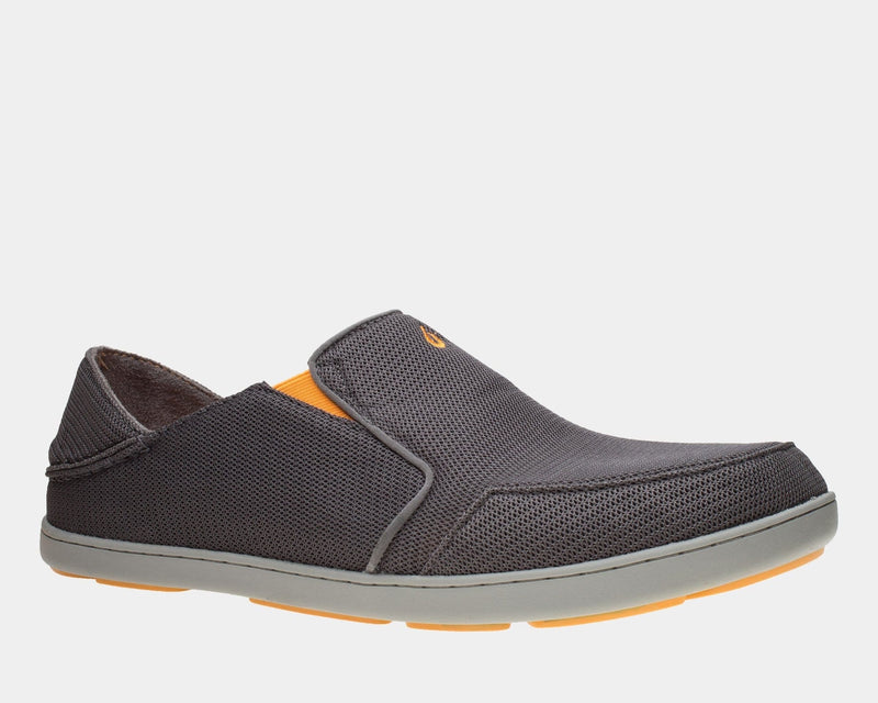 OluKai Nohea Mesh slip-on shoes in dark gray with breathable mesh upper, orange accents, and gray sole, side view.